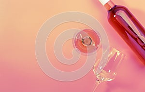 Rose wine glass with bottle on pink background. Rosado, rosato or blush wine tasting in wineshop, bar concept. Copy Space, top photo