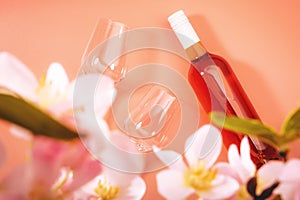 Rose wine glass with bottle on pink background. Rosado, rosato or blush wine tasting in wineshop, bar concept. Copy Space, top