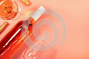 Rose wine glass with bottle on pink background. Rosado, rosato or blush wine tasting in wineshop, bar concept. Copy Space, top photo