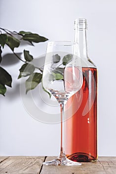 Rose wine glass with bottle on the white table. Rosado, rosato or blush wine tasting in wineshop, bar concept. Copy Space photo