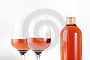 Rose wine glass with bottle on the white table. Rosado, rosato or blush wine tasting in wineshop, bar concept. Copy Space