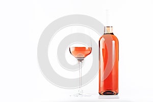 Rose wine glass with bottle on the white table. Rosado, rosato or blush wine tasting in wineshop, bar concept. Copy Space