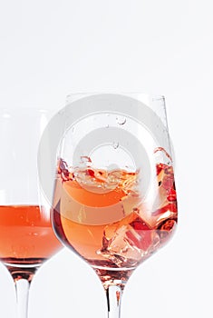 Rose wine glass with bottle on the white table. Rosado, rosato or blush wine tasting in wineshop, bar concept. Copy Space