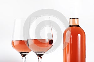 Rose wine glass with bottle on the white table. Rosado, rosato or blush wine tasting in wineshop, bar concept. Copy Space photo