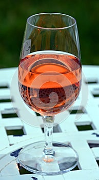 Rose wine glass on the white table photo