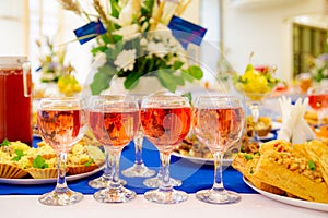 Rose wine in glasses on the Banquet table. Delicacies and snacks at the buffet. Catering