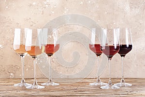 Rose wine glasses on the beige table. Rosado, rosato or blush wine tasting concept, negative space photo