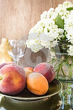 Rose wine in glasses. Rose wine on golden bottles background with flowers and fruits
