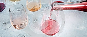 Rose wine panorama with wine poured into a glass at a tasting at a winery