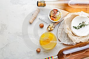 Rose wine pink champagne honey brie cheese nuts snacks appetizer set on Light gray stone background. Mediterranean food