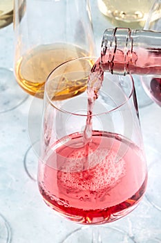 Rose wine pour at a tasting. Winetasting event. Elegant wineglass