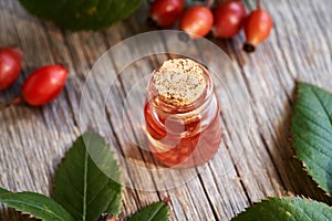 Rosehip seed oil in a glass bottle on a table