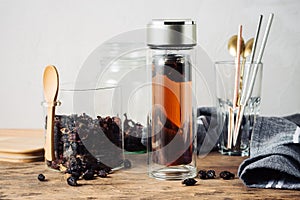 Rosehip tea in a bottle and dried rosehips