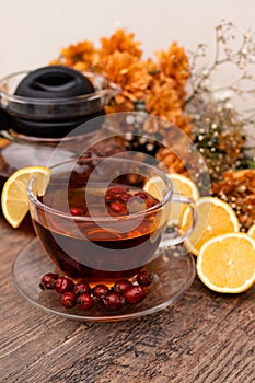 Rosehip tea in a clear teapot and cup. Autumn vitamins for health