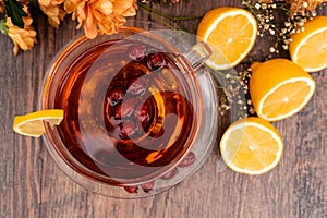 Rosehip tea with lemon in a clear cup. Autumn drink for colds