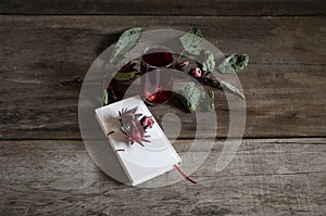 Roselle drink on Wood desk with a books note and repice