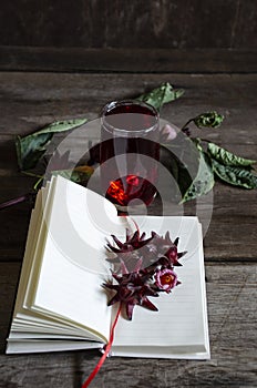 Roselle drink on Wood desk with a books note and repice