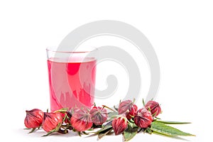 Roselle fruit and red water in glass on white background