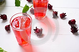 Roselle juice on wooden background, herbal organic tea for good healthy