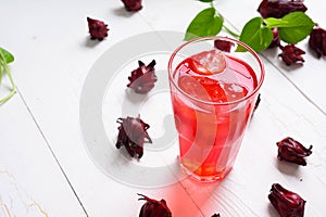 Roselle juice on wooden background, herbal organic tea for good healthy