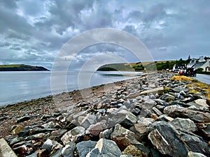 Rosemarkie Beach, Black Isle, Scottish Highlands. Beach view with rocks and stones, cloudy sky.