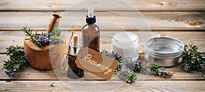 Rosemary aromatherapy. Essential oil and cosmetics, tag with text rosemary, banner. Wooden table background