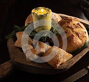 Rosemary butter candle and loaves of crusty breads