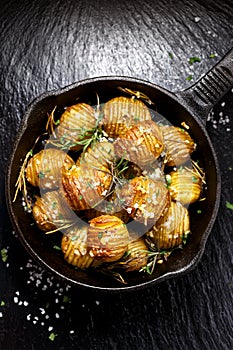 Rosemary and garlic roast potatoes on a cast iron pan