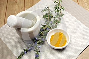 Rosemary herb and turmeric spice with mortar and pestle