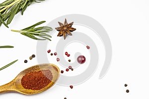 Rosemary, a spoonful of paprika, a mixture of peppers isolated on a white background