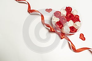 Roses in a box of red ribbon hearts white background. concept Valentine`s Day and Birthday