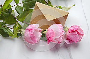 Roses and a craft envelope as a symbol of valentines day