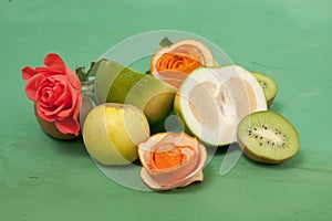 Roses and fruits on a green background