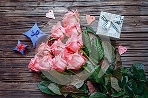 Roses and gift box over old wood background