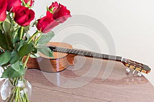 Roses and guitar lying on the table