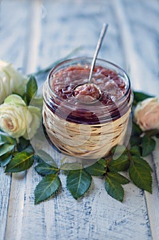 roses jam. food background with a glass jars full of tea rose jam