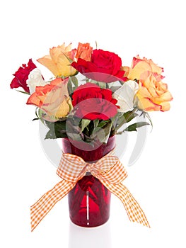 Roses in a red glass vase photo