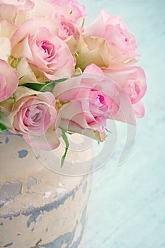 Roses in a shabby chic metal bucket