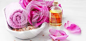 Roses spa setting with bath salt, roses flowers, bath rose oil,