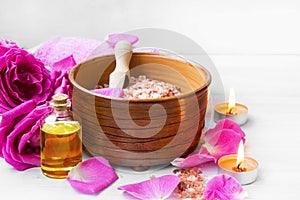 Roses spa setting with bath salt, roses flowers, bath rose oil,