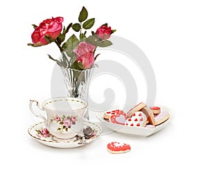 Roses, teacup, cookies photo