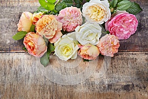 Roses on wooden background.Top view with copy space