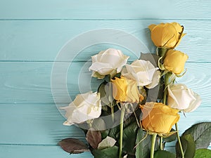 Roses yellow on a minty wooden background