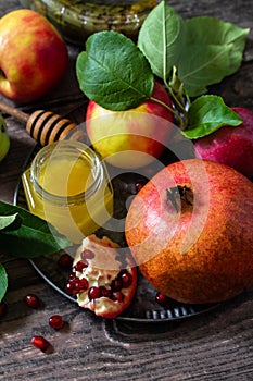 Rosh hashanah hashana - jewish new year holiday concept. Traditional symbols: honey, fresh apples, pomegranate and shofar