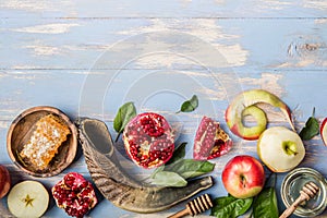 Rosh hashanah  Hashana - jewish New Year holiday concept. Traditional symbols: Honey jar and fresh apples with pomegranate and