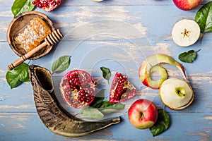 Rosh hashanah  Hashana - jewish New Year holiday concept. Traditional symbols: Honey jar and fresh apples with pomegranate and