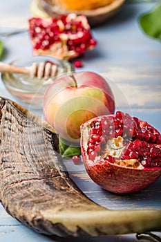 Rosh hashanah  Hashana - jewish New Year holiday concept. Traditional symbols: Honey jar and fresh apples with pomegranate and