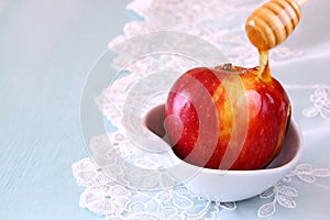 Rosh hashanah (jewesh holiday) concept - honey and apple over wooden table. traditional holiday symbols.