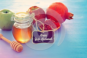 Rosh hashanah jewesh holiday concept - honey, apple and pomegranate traditional holiday symbols