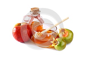 Rosh hashanah (jewesh holiday) concept - honey, apple and pomegranate on white. traditional holiday symbols.